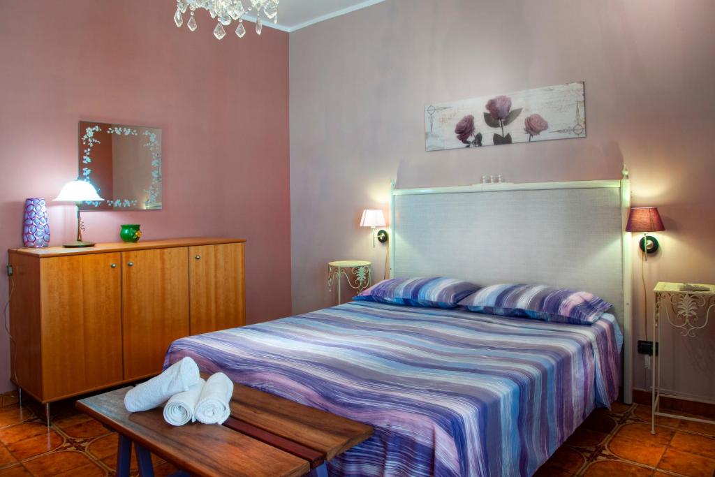 a bedroom with a bed and a table with shoes on it at Casa Libertà in Castellammare del Golfo