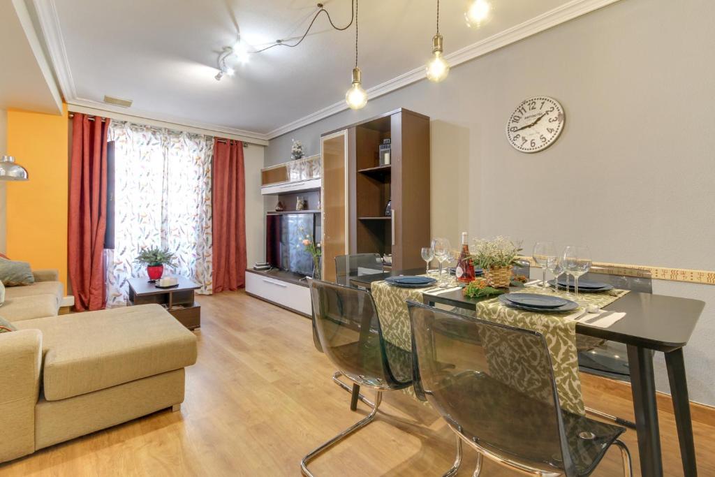 a living room with a dining room table with chairs at Central Salamanca Apartment in Salamanca