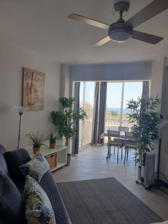 a living room with a couch and a ceiling fan at Studio El Faro in Torrox Costa