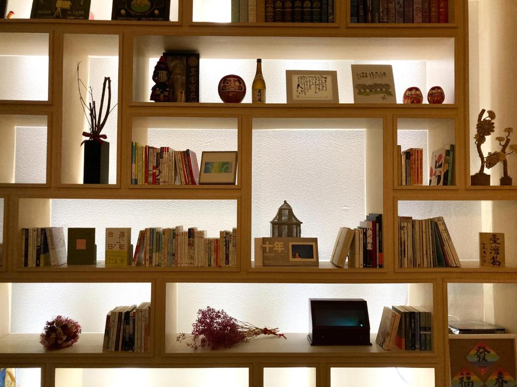 a book shelf filled with lots of books at 4Plus Hostel in Taipei