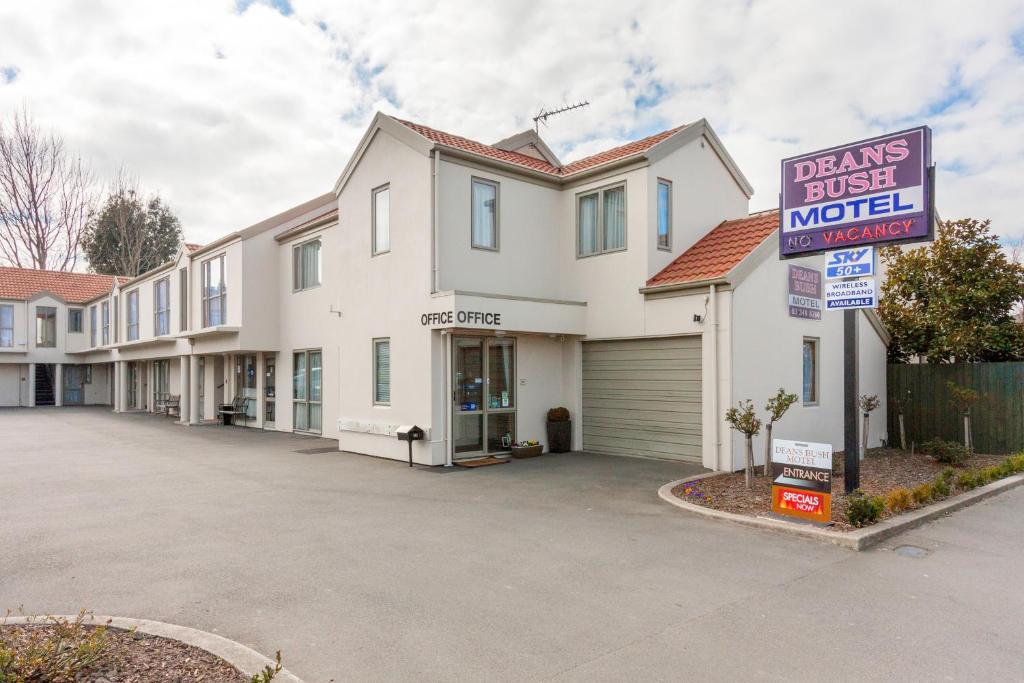 a house with a sign that reads loans just married at Deans Bush Motel in Christchurch