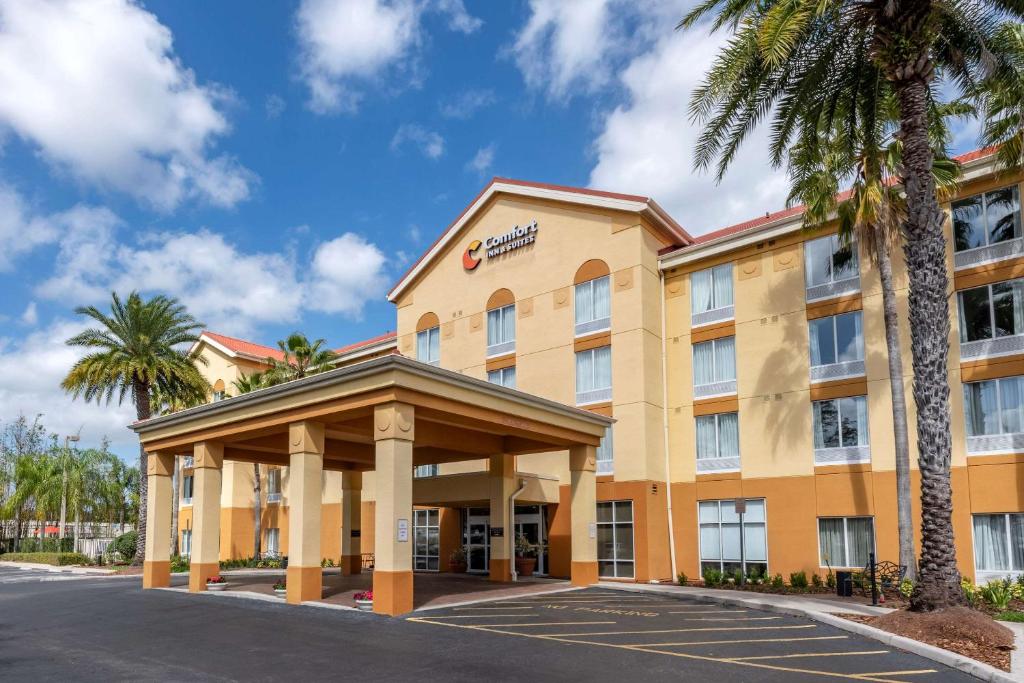 a hotel with a gazebo and palm trees at Comfort Inn & Suites Orlando North in Sanford
