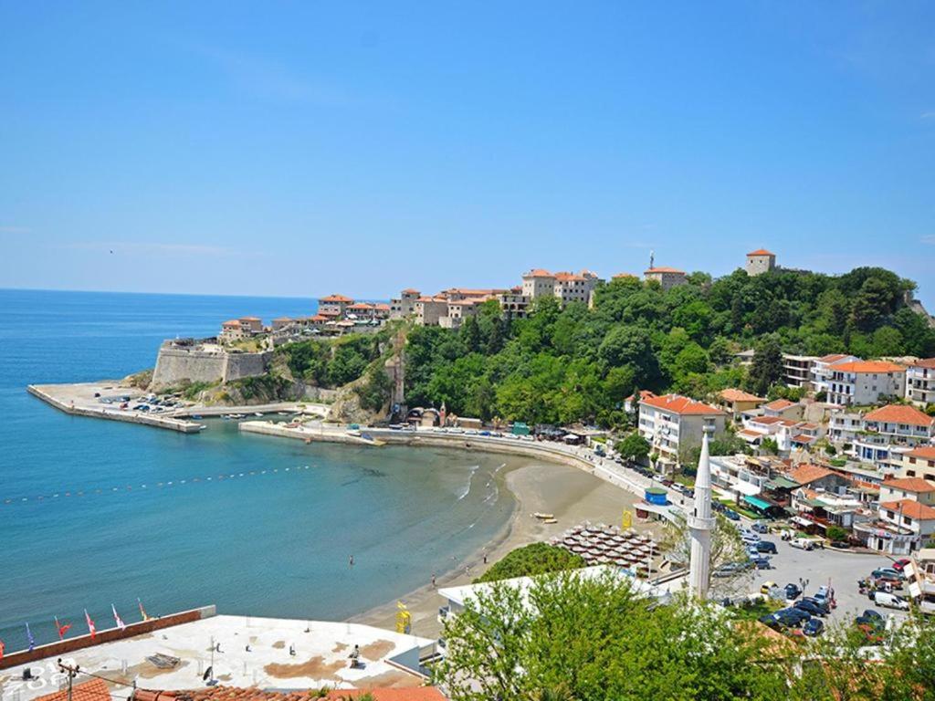 a view of a beach with buildings and the ocean at Guesthouse Sidro in Ulcinj