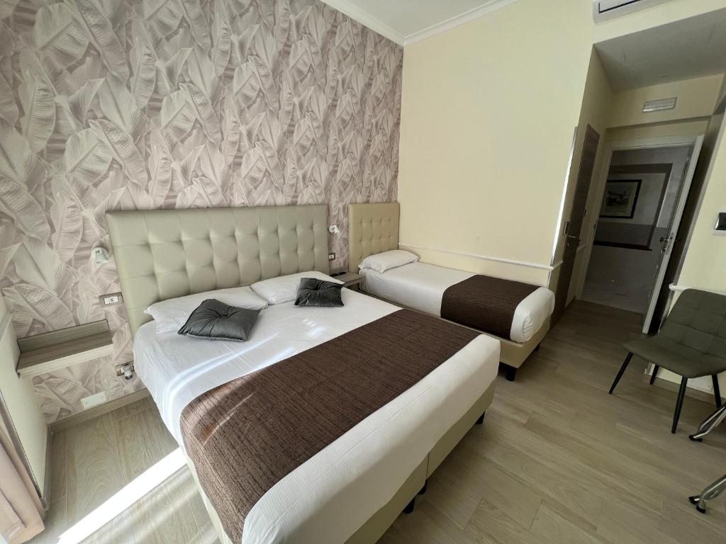 Una cama o camas en una habitación de Hotel Le Petit