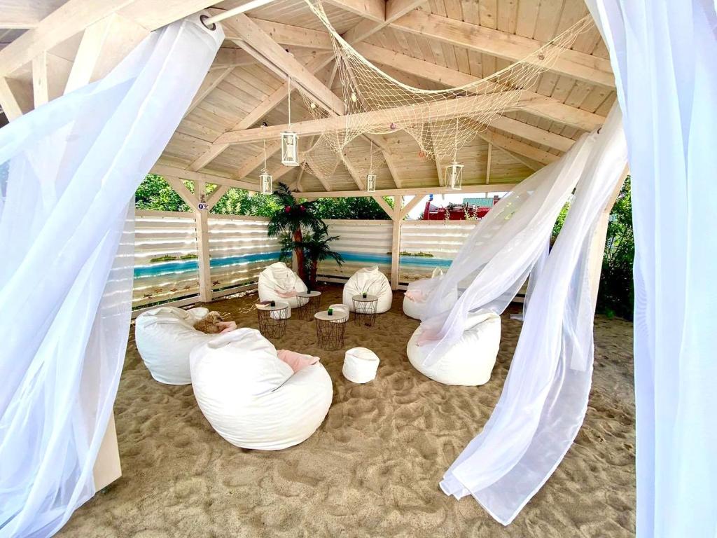 a group of white bean bag chairs in a tent at LABALAND in Gąski