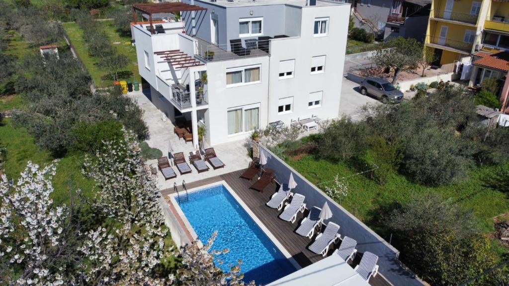 an aerial view of a house with a swimming pool at Guest House Dragić - Anex in Zadar