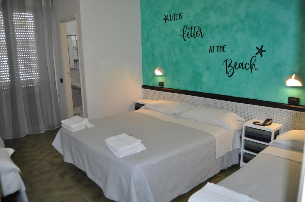 Postel nebo postele na pokoji v ubytování Hotel Rigobello