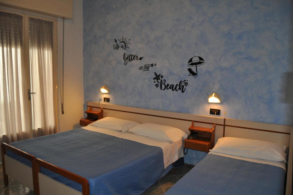 Säng eller sängar i ett rum på Hotel Rigobello