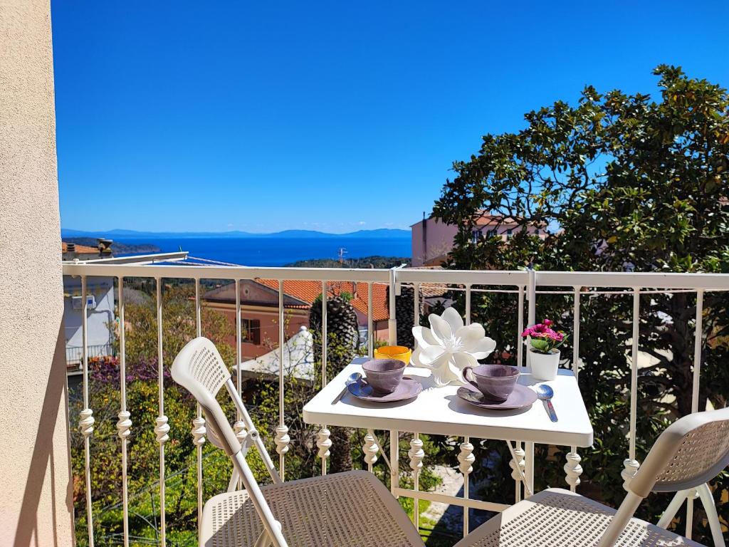 a white table and chairs on a balcony at Casa Argentina in Capoliveri