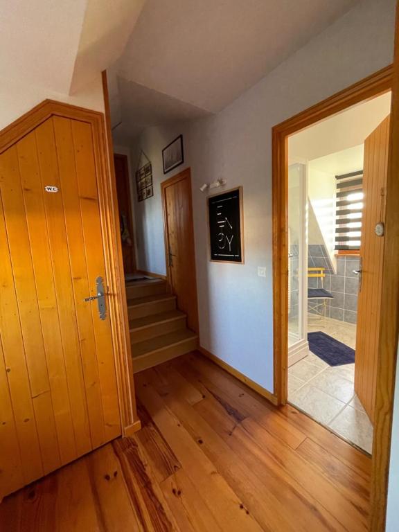 a hallway with a door and a staircase in a house at Gîte Pressoir Armand in Saint Gatien des Bois