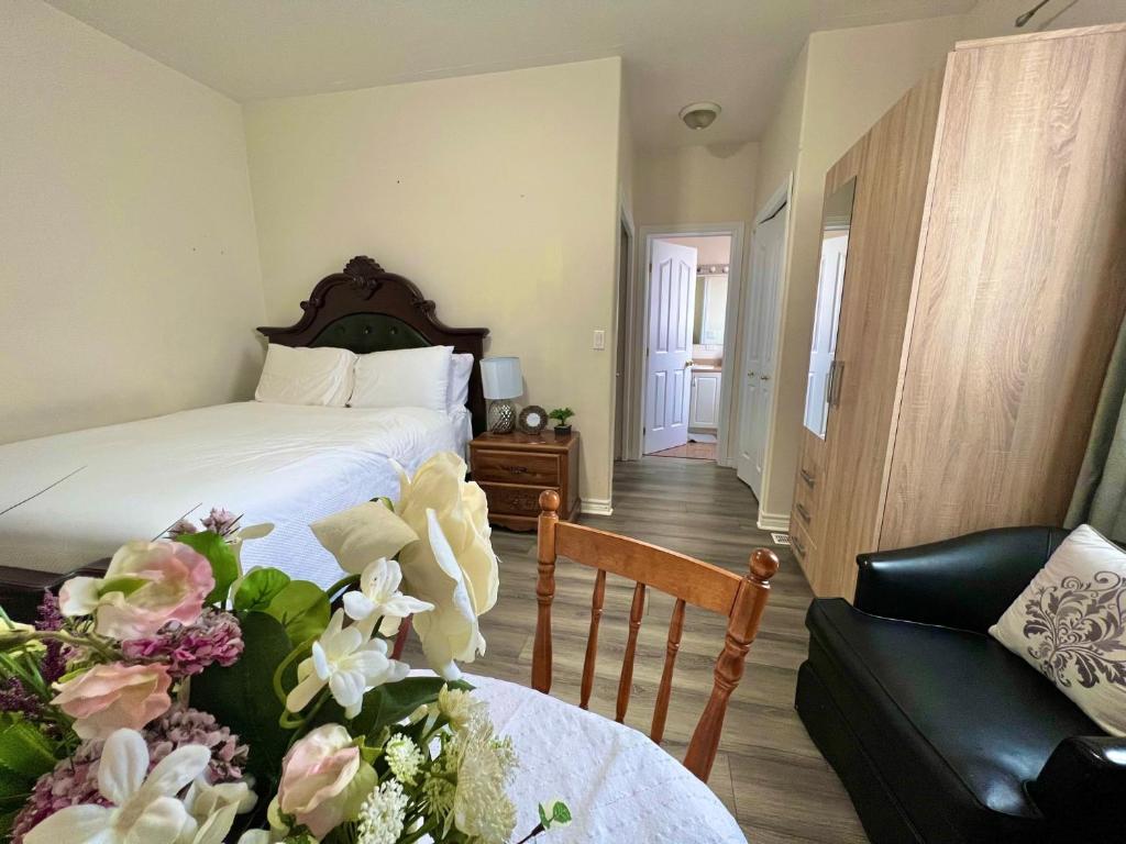 a bedroom with a bed and a table with flowers at May Flowers in Kingston