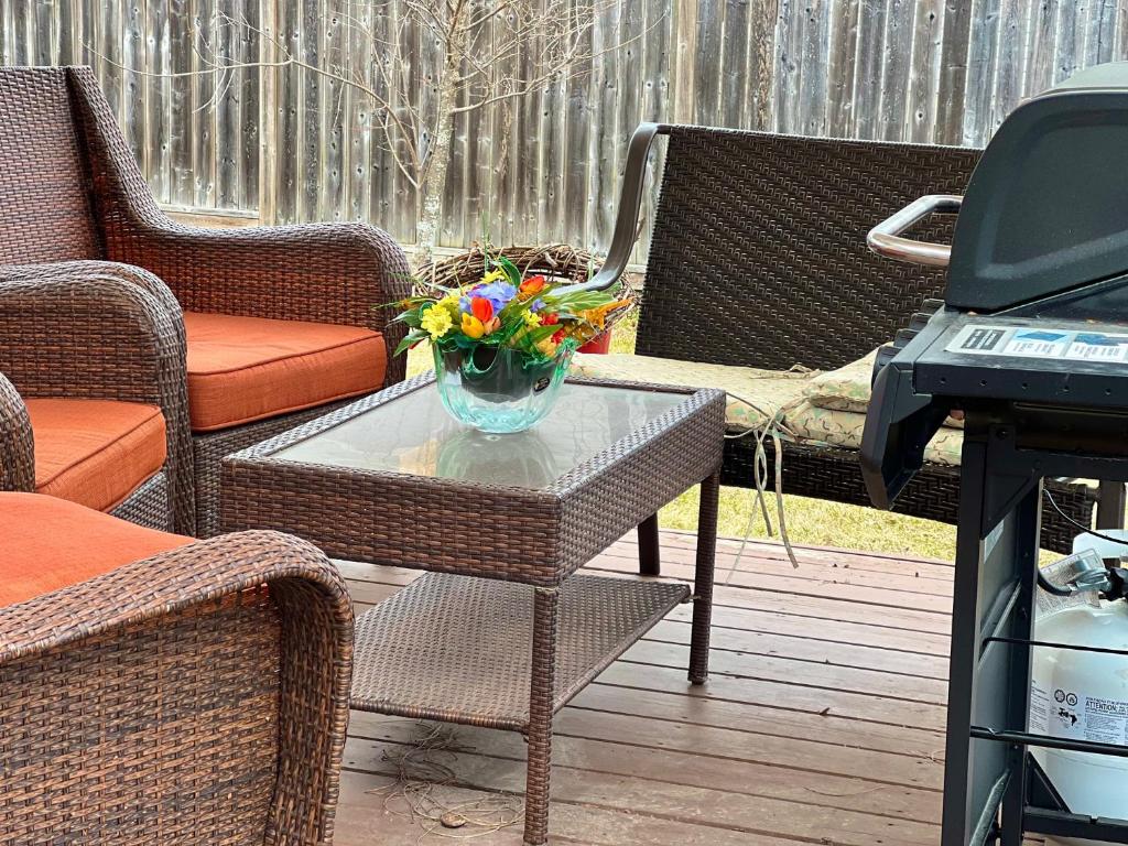 a table with a vase of flowers on a patio at May Flowers in Kingston