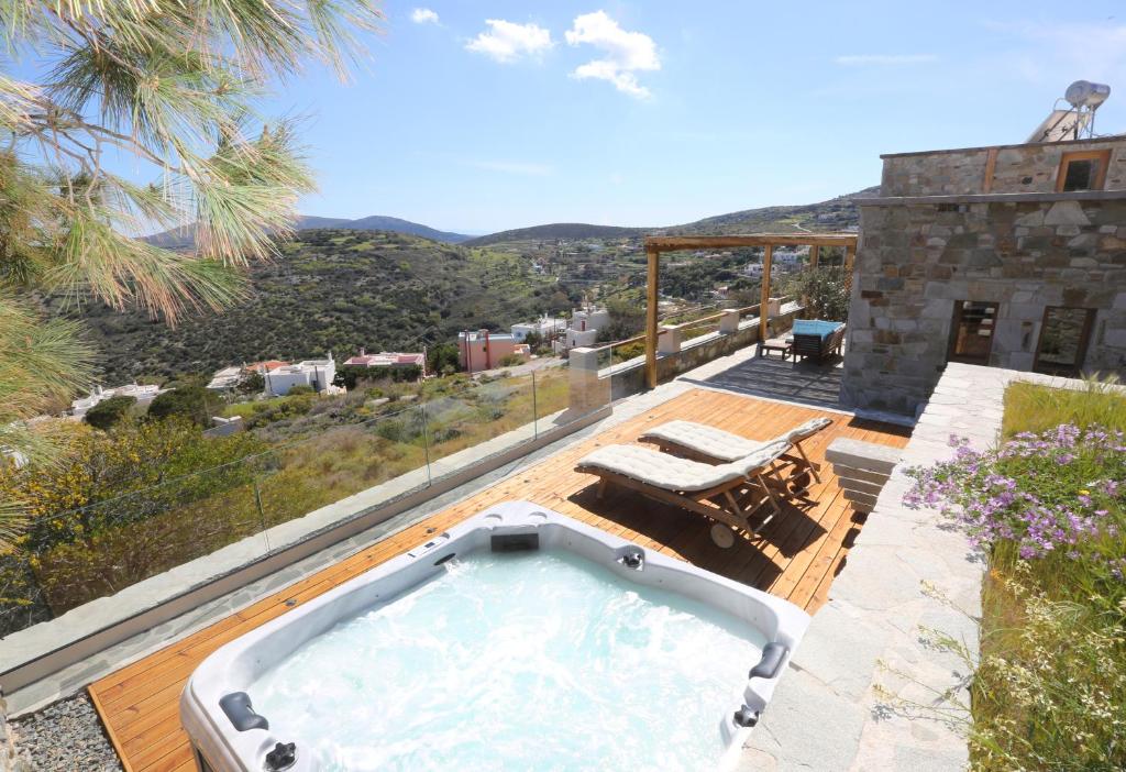 a hot tub on the deck of a house at Magna Grecia Residence Panoramic View in Episkopíon