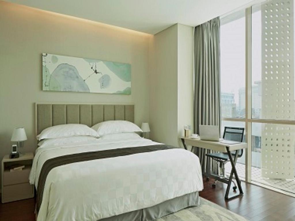 Postel nebo postele na pokoji v ubytování Fraser Residence Menteng Jakarta