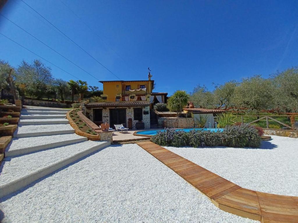 a house with a pathway leading to a yard at Villa Daniela in Camaiore