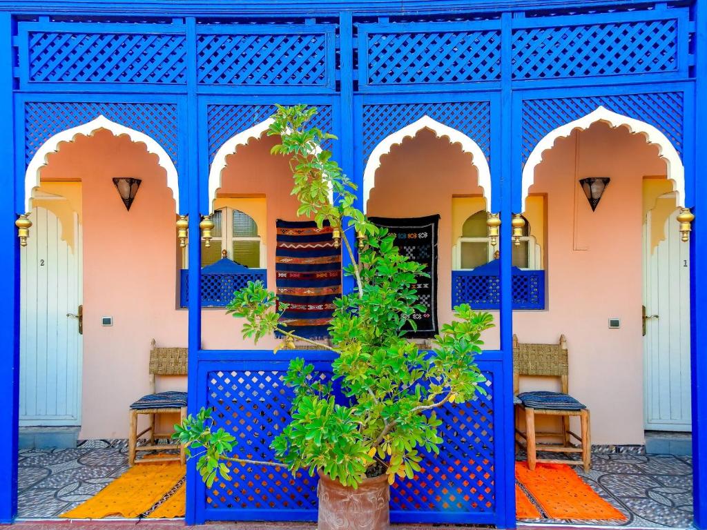 a blue building with a staircase in the courtyard at Le Bleu House in Marrakech
