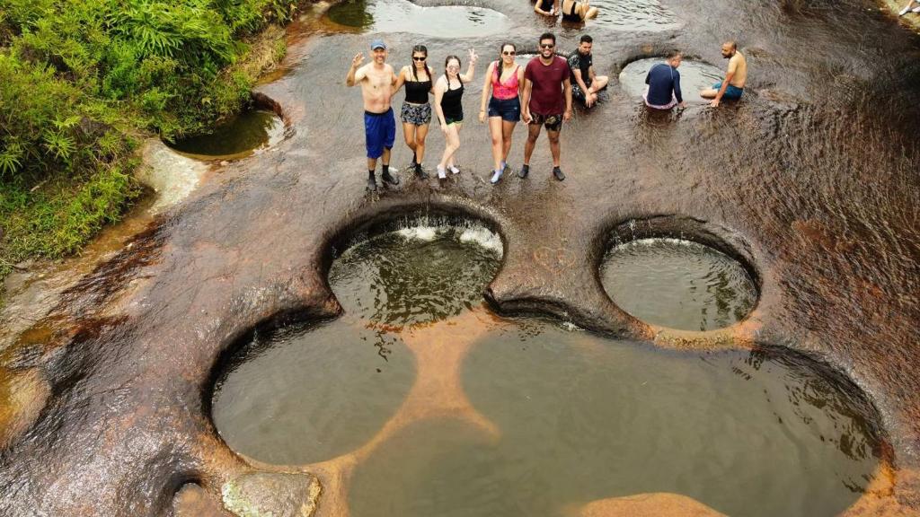 a group of people standing in the middle of a river at Hotel Terra Bella in Guadalupe