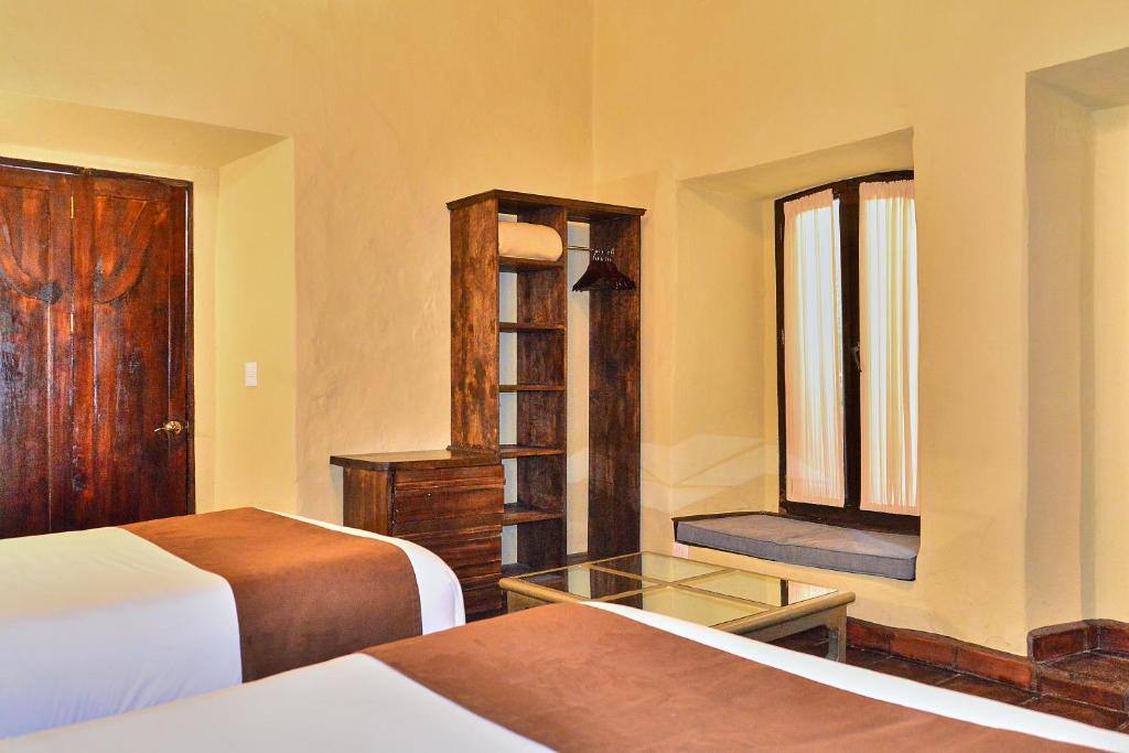 Postel nebo postele na pokoji v ubytování Hotel Mesones 49