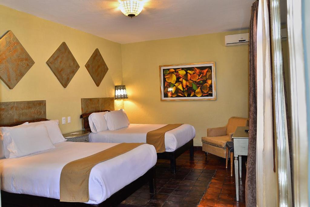 Postel nebo postele na pokoji v ubytování Hotel Mesones 49