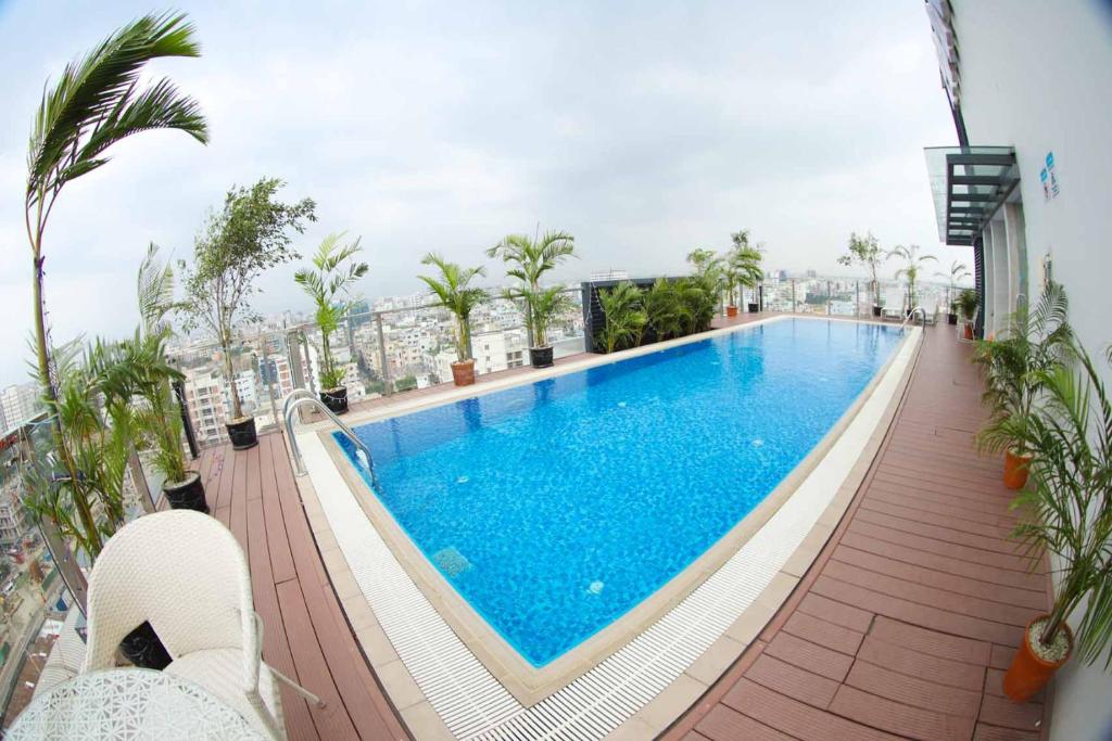 a swimming pool on the roof of a building at HANSA- A Premium Residence in Dhaka