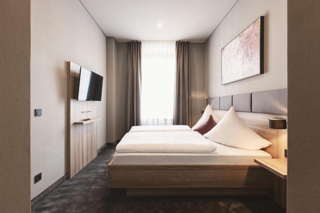 Postel nebo postele na pokoji v ubytování Hotel Das Bischof