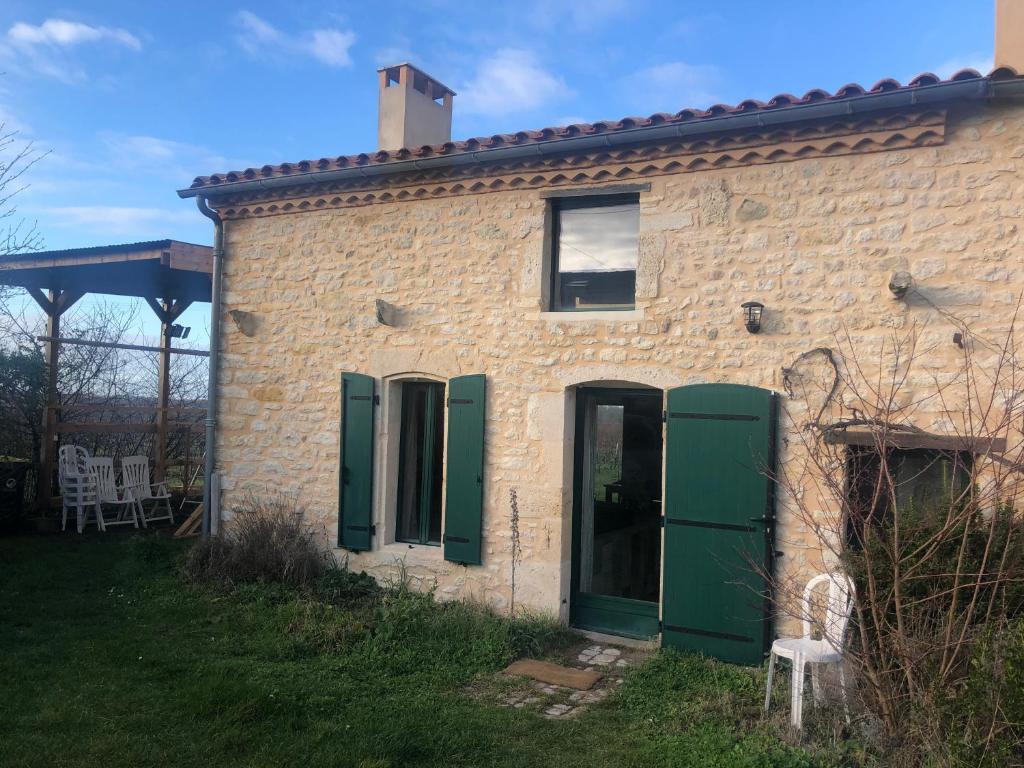 a brick house with green doors and a yard at Chai Crann Piorra 2 in La Valade