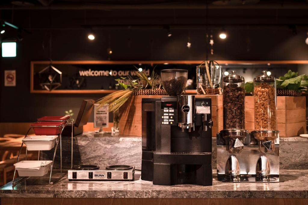 a counter with a coffee maker on a table at Hub Hotel Kaohsiung Yawan Branch in Kaohsiung