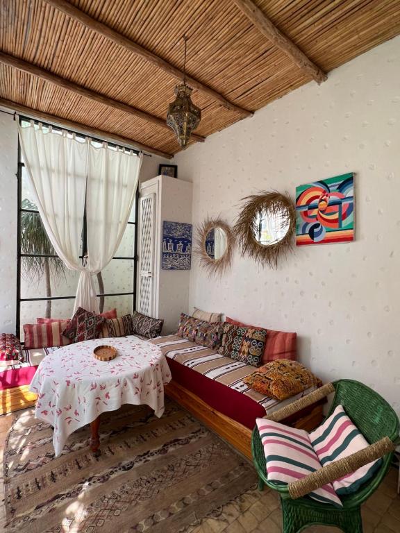 a living room with a couch and a table at RIAD OASIS D'ASILAH in Asilah