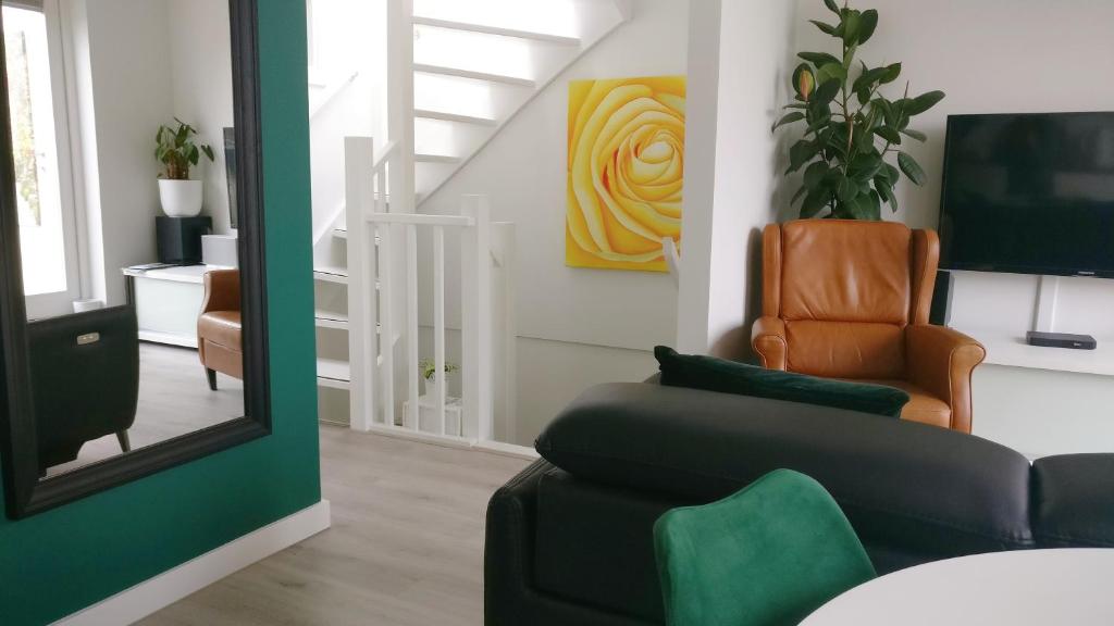a living room with a couch and a chair at Designed Penthouse, Amsterdam city center in Amsterdam