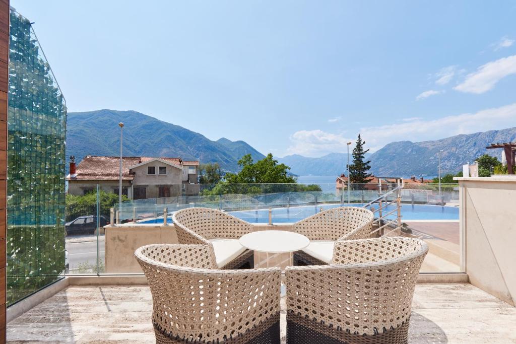 a patio with a table and chairs on a balcony at Minka in Kotor