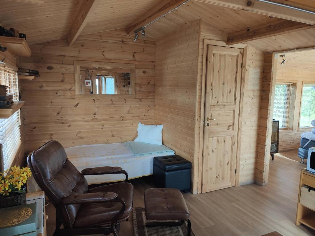 1 dormitorio con 1 cama en una cabaña de madera en Cosy Cabin by Lake & Woods with Views, en Selfoss