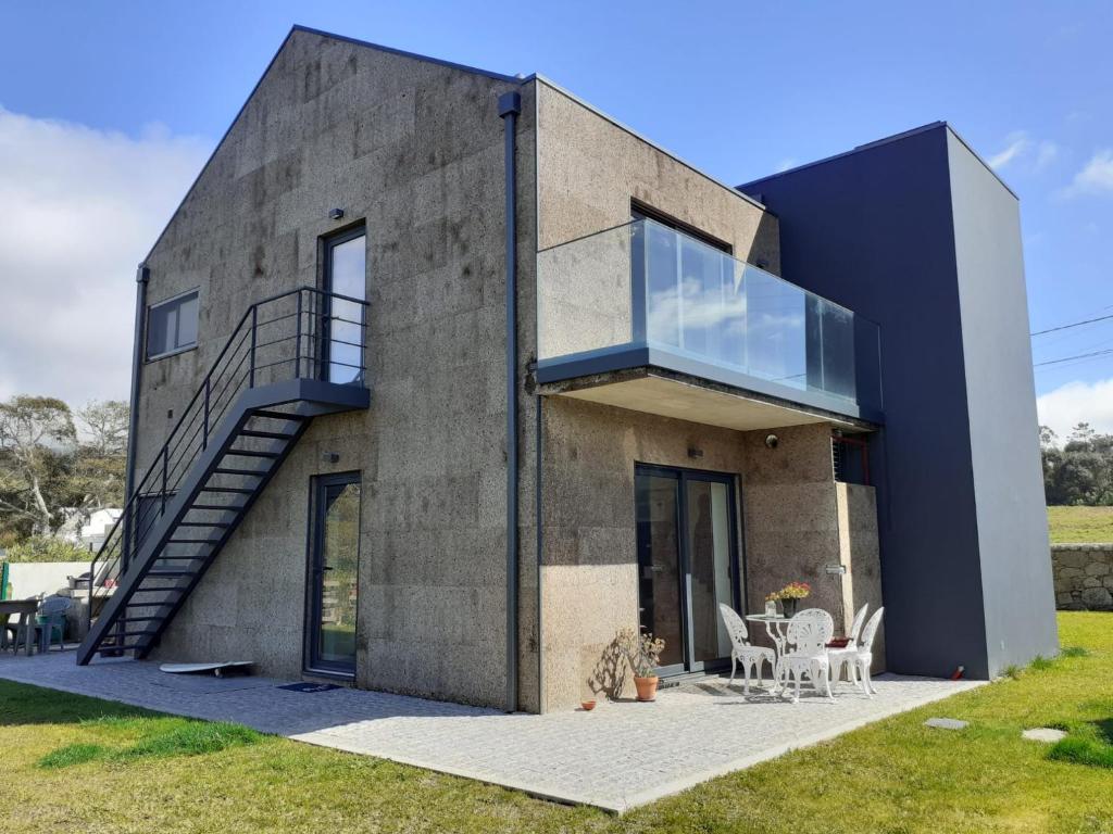 una casa sostenible con una escalera en el lateral. en Cork House, en Vila Praia de Âncora