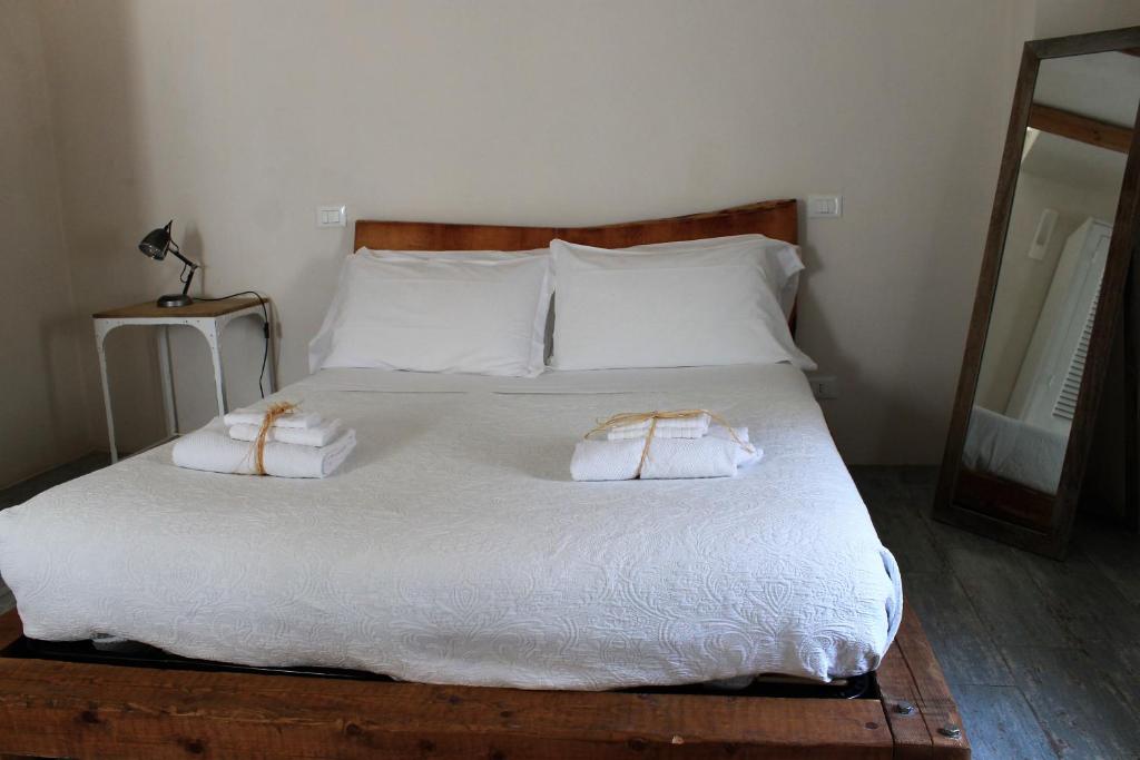 a bed with two pillows on top of it at Dei Serafini in Polignano a Mare