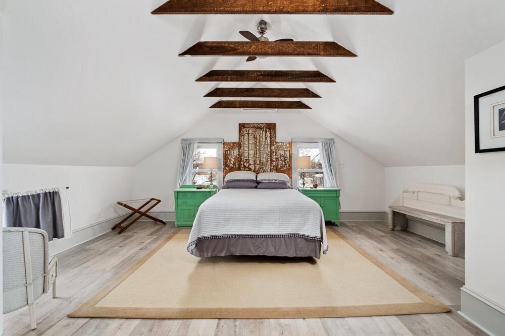 a bedroom with a bed in the middle of the room at The 1885 Suites in Picton