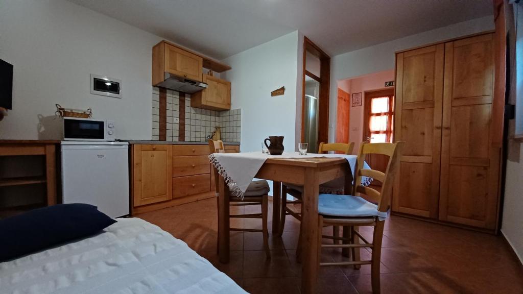 a kitchen and dining room with a table and chairs at Apartments Bobi in Tolmin