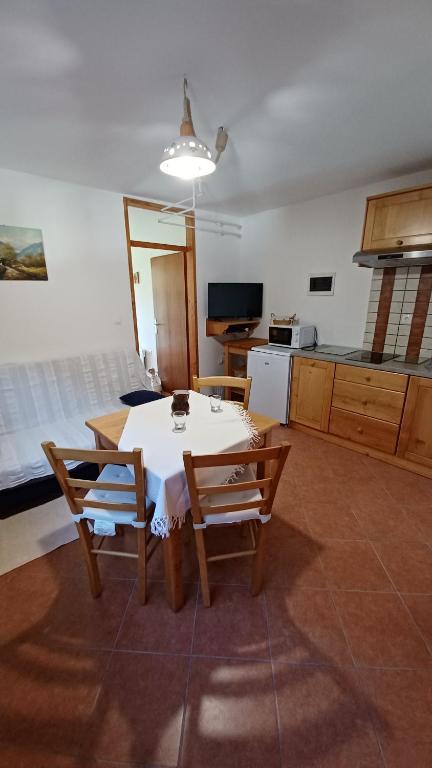 a kitchen with a table and chairs in a room at Apartments Bobi in Tolmin