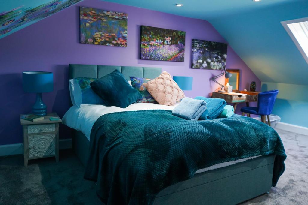 a purple bedroom with a bed with a teddy bear on it at The Art Bank in Dalbeattie