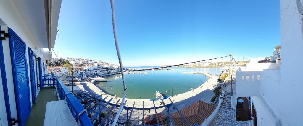 a balcony with a view of a harbor with boats at Esperides Sea in Andros