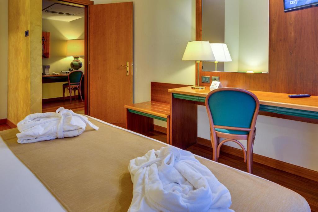 Posteľ alebo postele v izbe v ubytovaní Hotel Raffaello