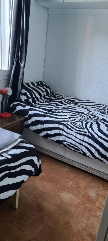 a zebra print bed in a room with a window at maison nathalia in Jávea