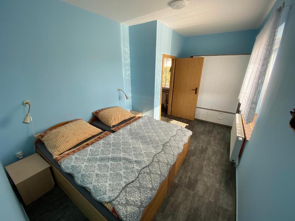 a bedroom with a bed in a blue room at Apartment Martinec in Nové Město nad Metují