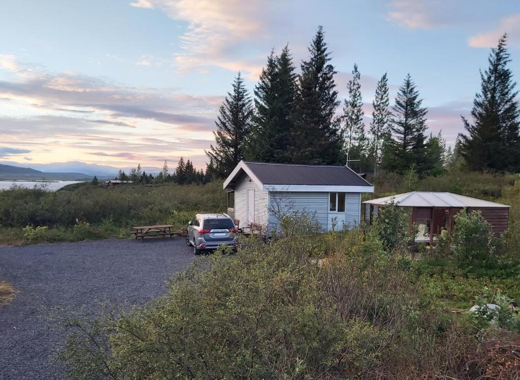 a car parked in front of a small building at Cosy Cottage in Golden Circle near Thingvellir in Vaðlækir