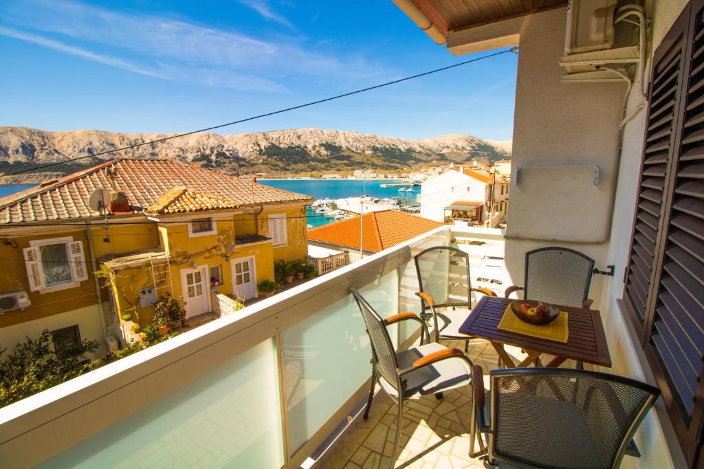 a balcony with chairs and a view of the water at Apartment Mario with Terrace and Sea View in Baška