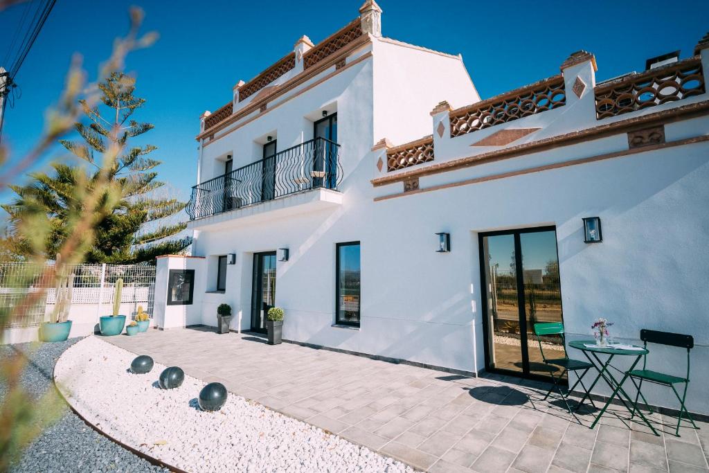 a white house with a table in front of it at L'Hotelet del Delta - adults in Deltebre