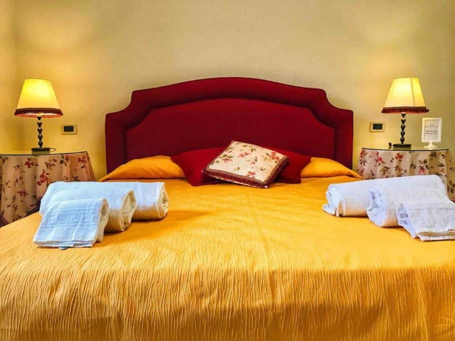 a large yellow bed with two towels on it at Monolocale & Suite Casa Santicelli Maratea in Maratea