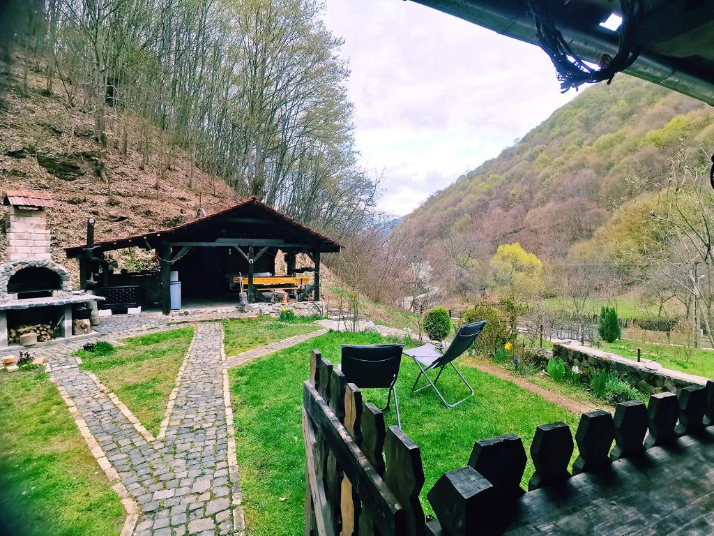 a backyard with a gazebo and a table and chairs at Casuta Bucuriei in Hunedoara