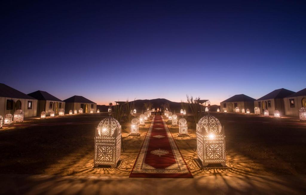 a row of lights on a street at night at Luxury Desert Camp Amanar in Merzouga