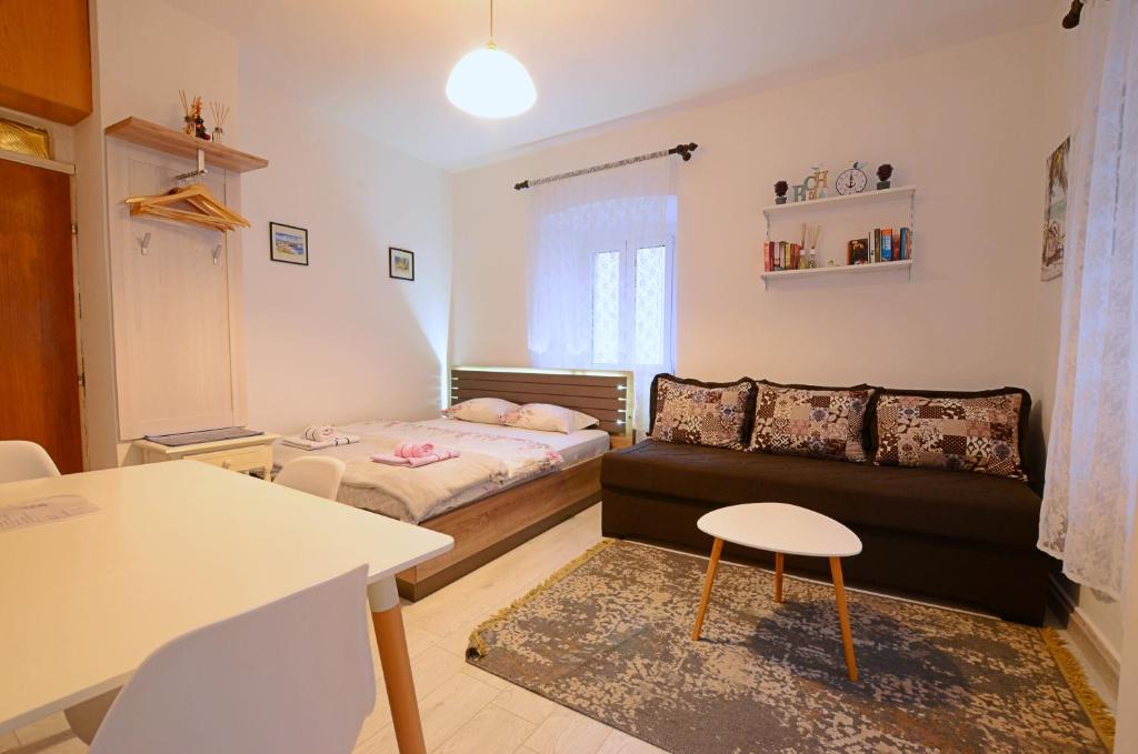 a small living room with a couch and a table at Old Town Experience - Studio Apartment in Budva