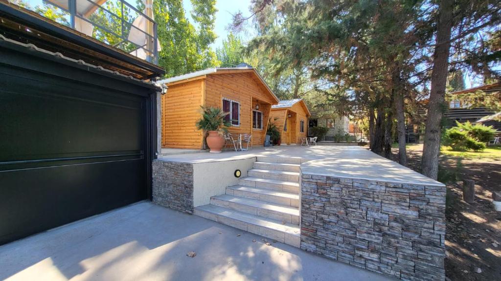 a house with a gate and stairs to a house at Cabañas swissminiatur in Cacheuta