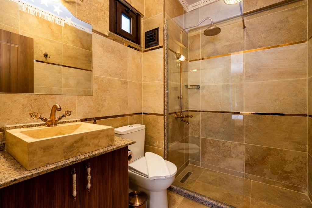 a bathroom with a toilet and a sink and a shower at The First Ottoman Dream in Istanbul